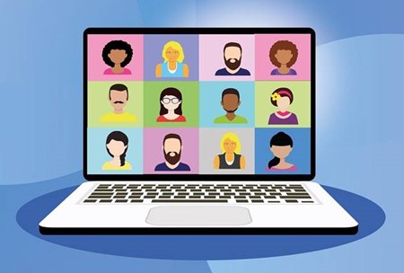 laptop with a screen showing 12 portraits participating in a virtual meeting